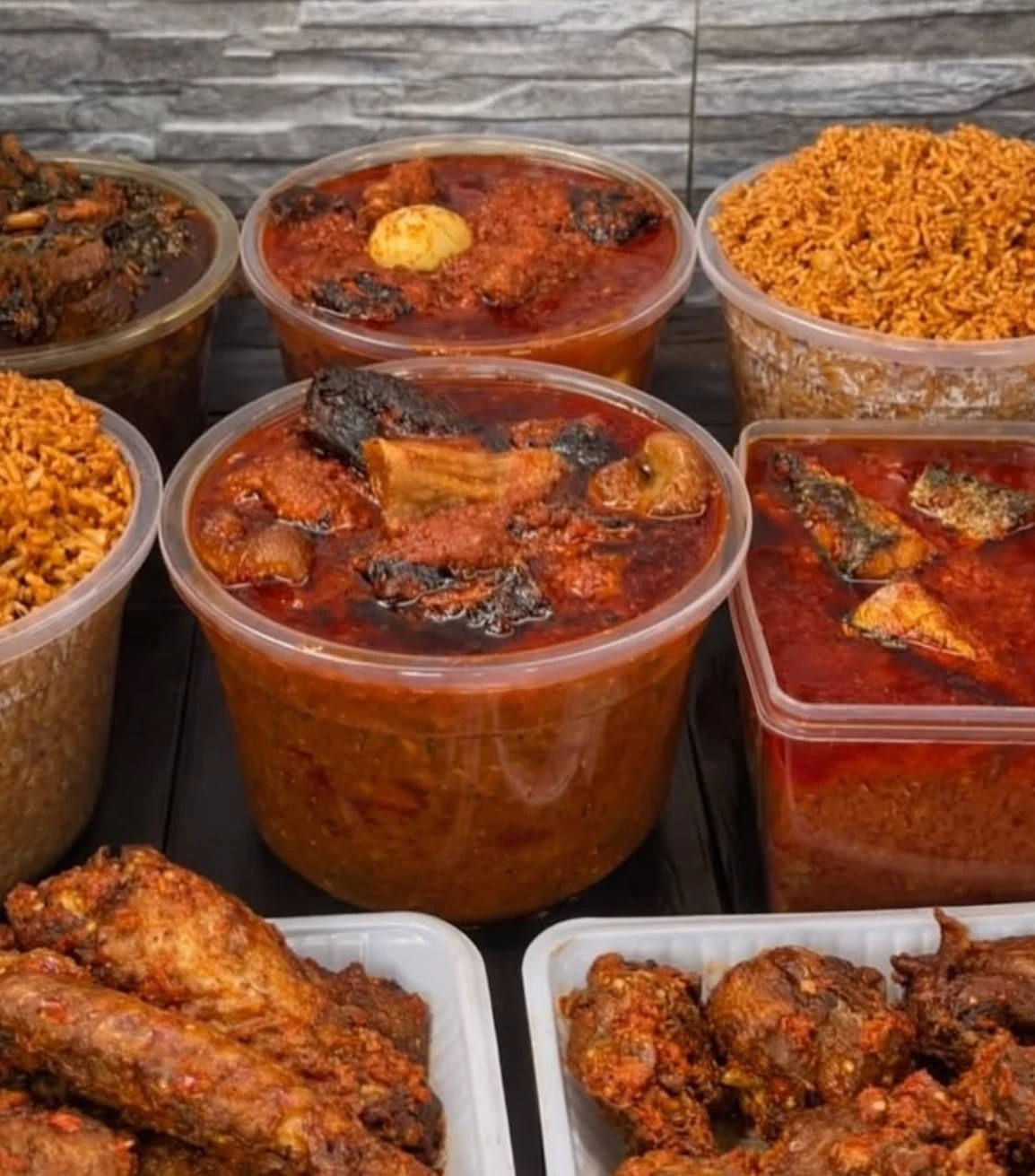 Prepared portions of rice, chicken and stew in takeaway containers
