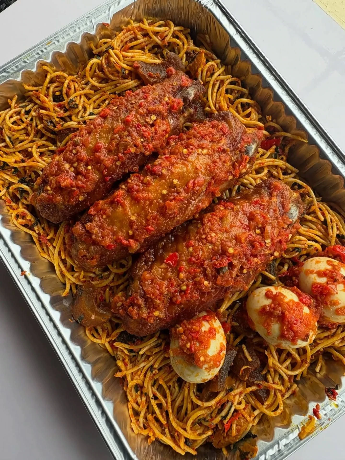 Peppered fish fillets over noodles with eggs