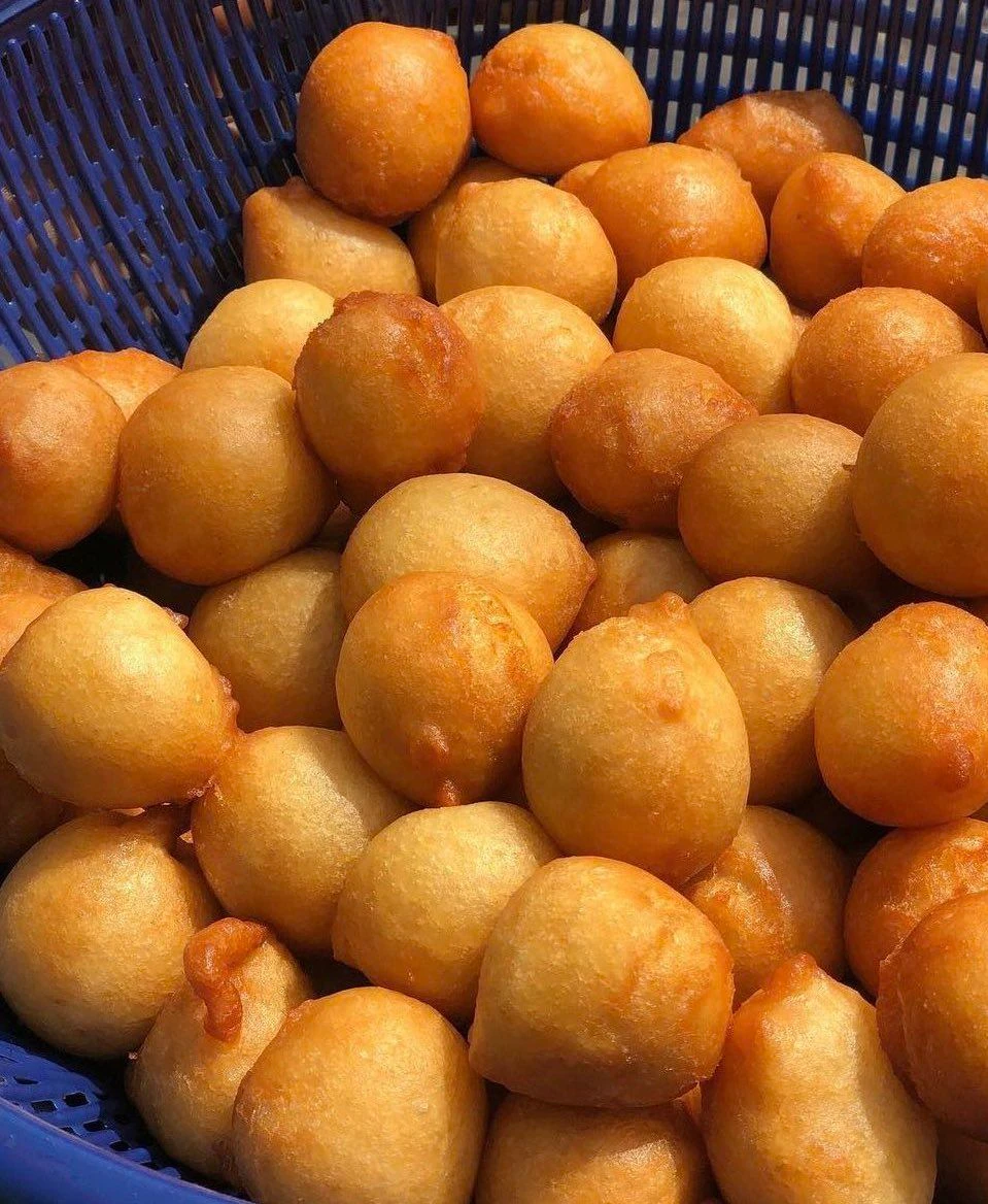Golden puff-puff pastries served fresh